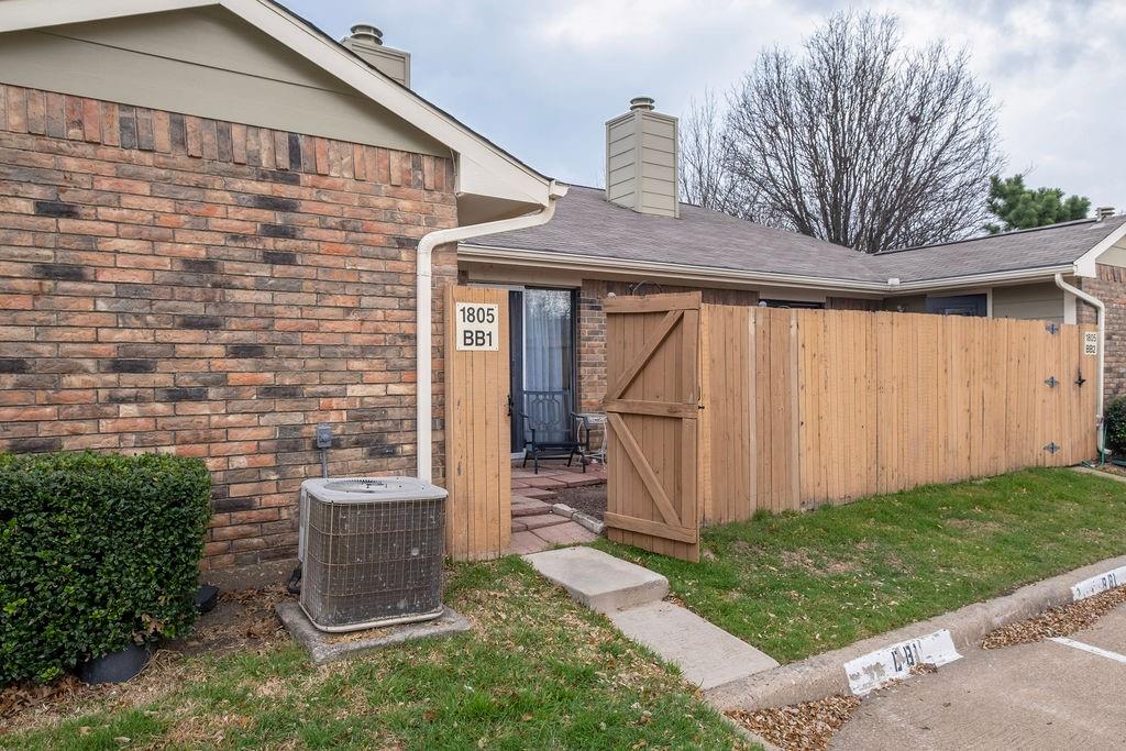 Brick exterior featuring a private fenced patio area Brick exterior featuring a private fenced patio area