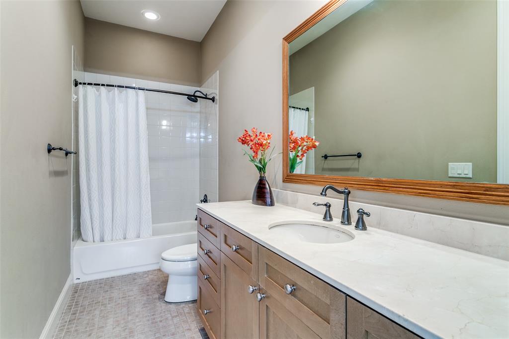 Downstairs bathroom with a spacious vanity offering ample counter space and functionality.