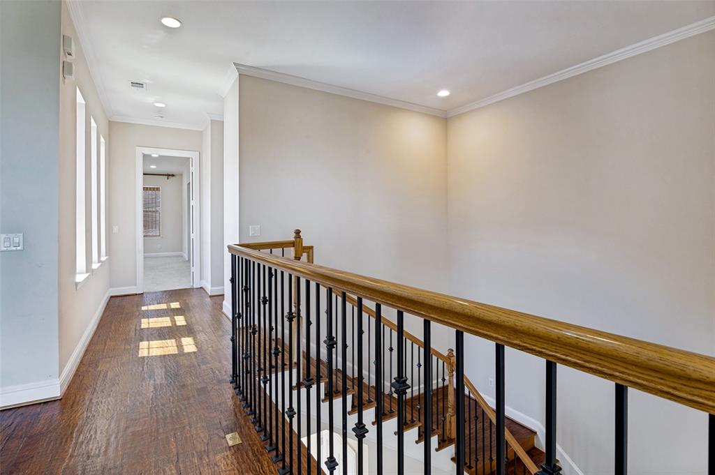 Light filled hallway with an abundance of windows overlooking the interior courtyard.