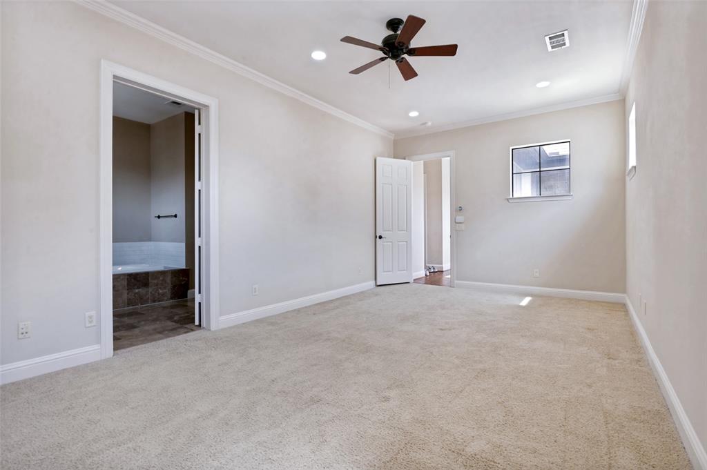 Oversized primary bedroom with plenty of room for a sitting area, additional furnishings, or a private workspace.