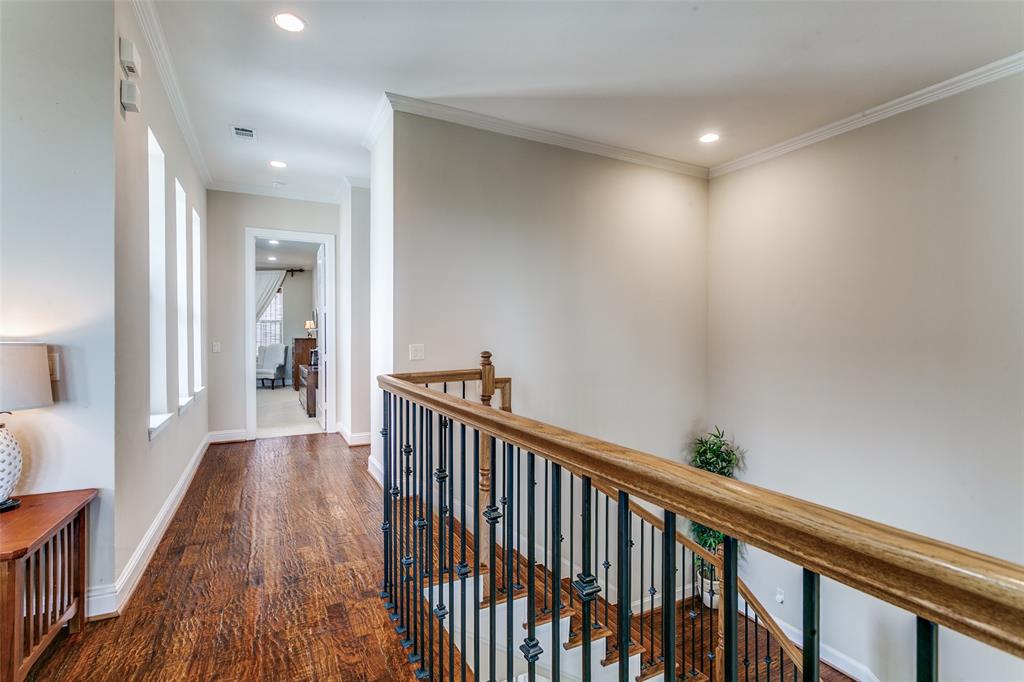 Bright hallway lined with expansive windows that bring in abundant natural light.