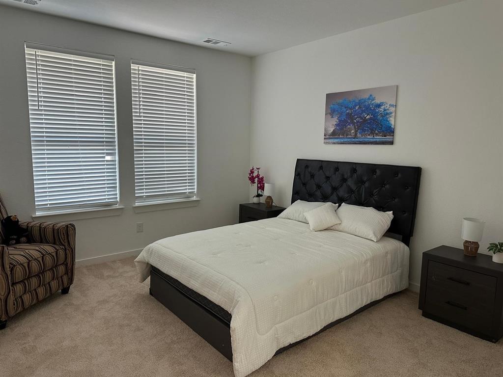 Neutral wall tones complement carpeted flooring throughout
