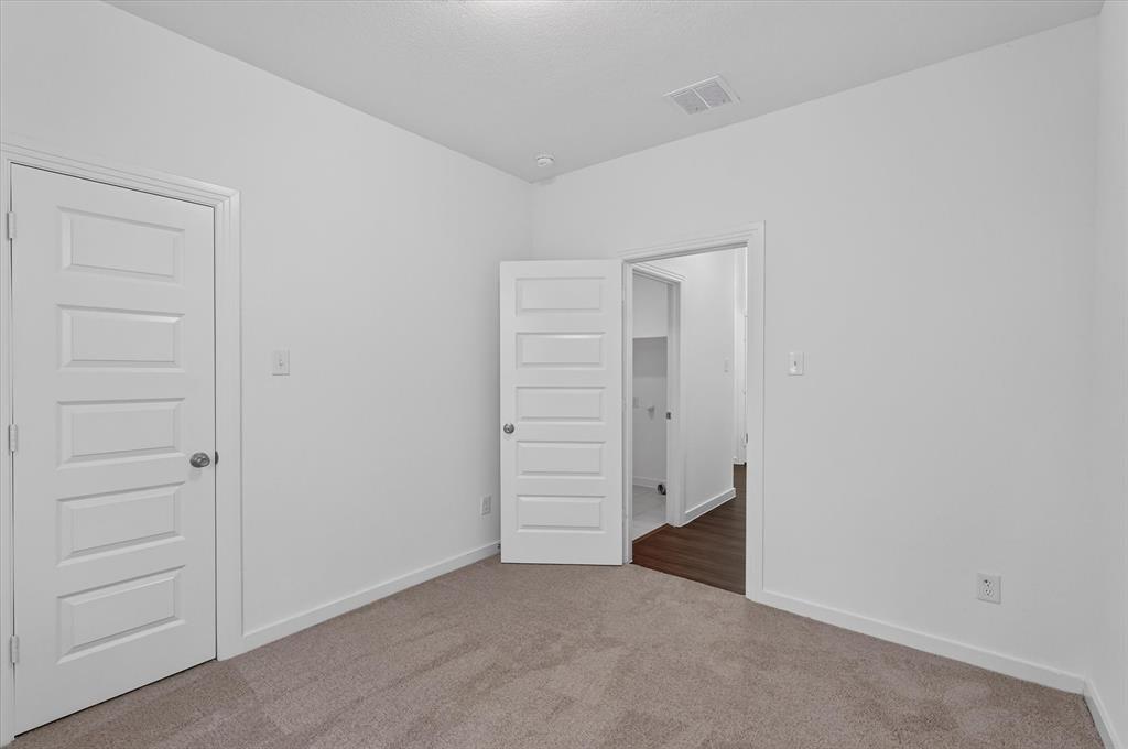 Neutral wall tones with plush carpeting complement the modern five-panel interior doors
