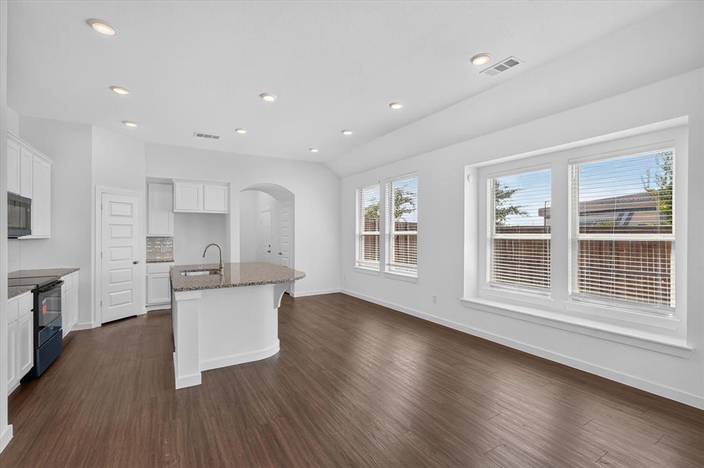 Open-concept living space with dark wood-finish flooring