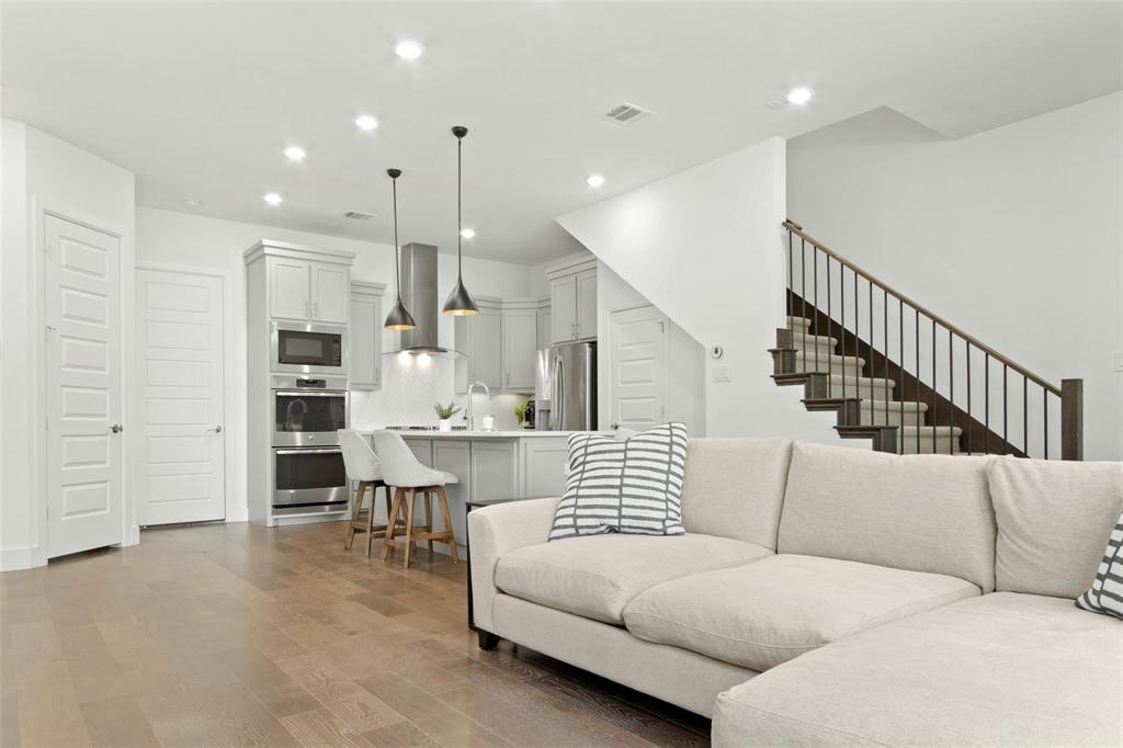 Open-concept living space with wood-finish flooring