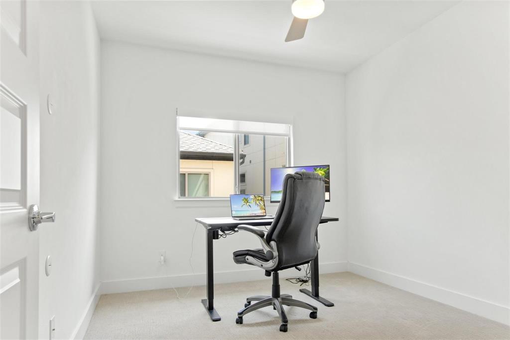 Bright room featuring a single window, a ceiling fan, and neutral carpeting