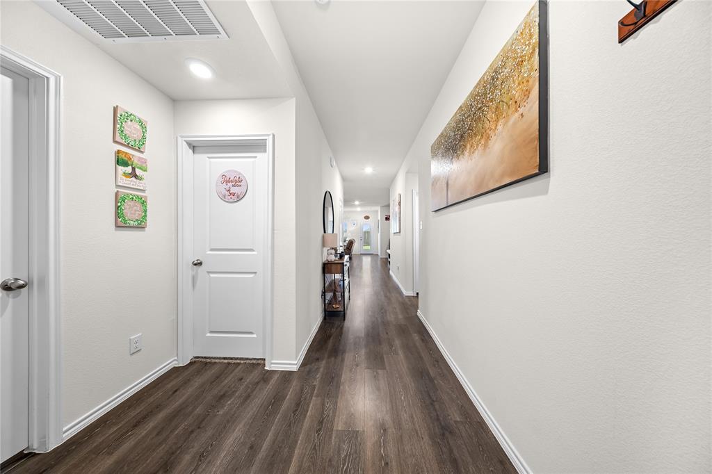 Hallway featuring wood-finish flooring, recessed lighting, white walls, white trim, and white paneled doors