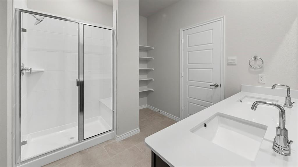 Dual vanity with integrated sinks and chrome fixtures, featuring a white countertop
