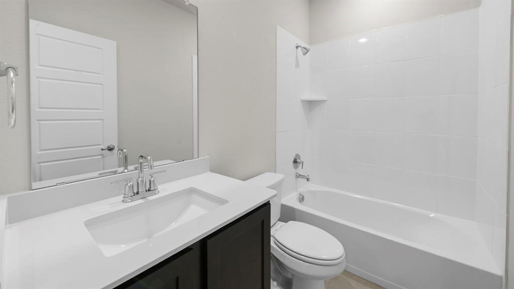 Modern bathroom featuring a sleek vanity with an integrated rectangular sink, white quartz countertop, and chrome faucet hardware