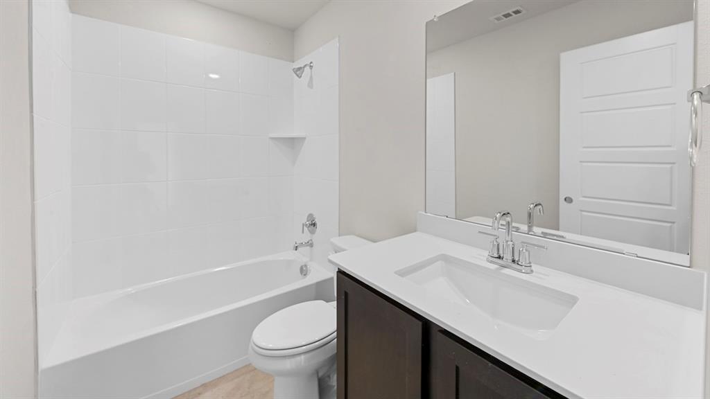 Contemporary bathroom featuring a dark wood-finish vanity with a white countertop and integrated sink