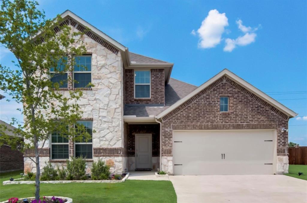 Two-story residence featuring a combination stone and brick facade, a two-car garage, and a concrete driveway