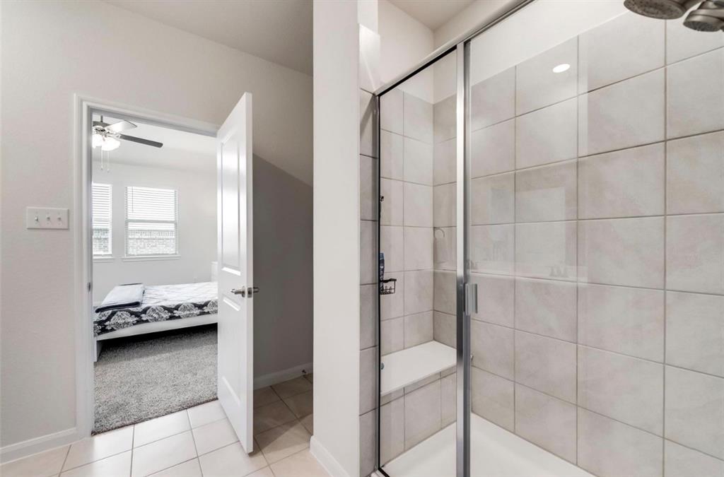 Spa-inspired primary bathroom featuring a frameless glass-enclosed shower with subway tile surround, polished chrome fixtures, and recessed ceiling lighting
