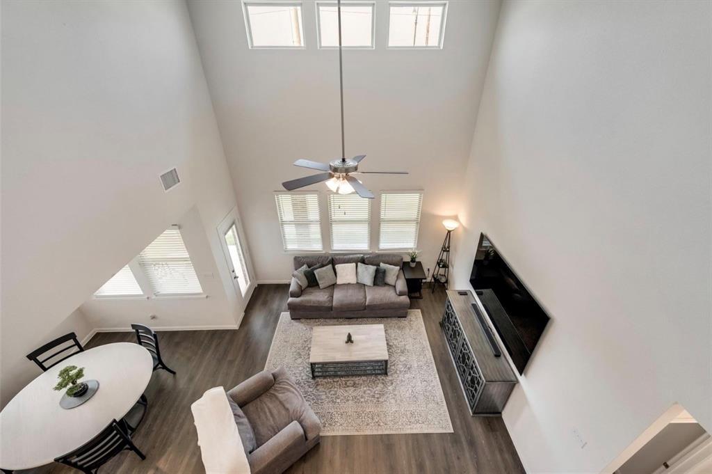 Vaulted ceiling with multiple windows and a ceiling fan