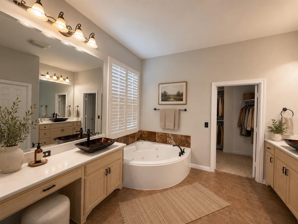 Dual sink vanity with light wood cabinetry and white countertops