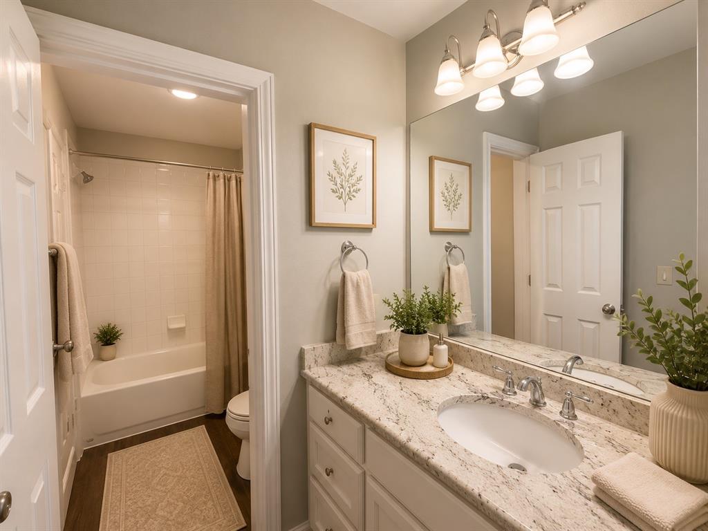 Bathroom vanity featuring an integrated oval sink and a light-toned countertop