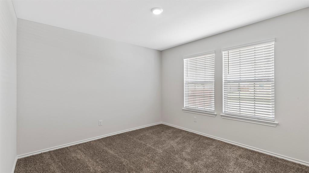 Neutral wall tones complement the durable carpet flooring