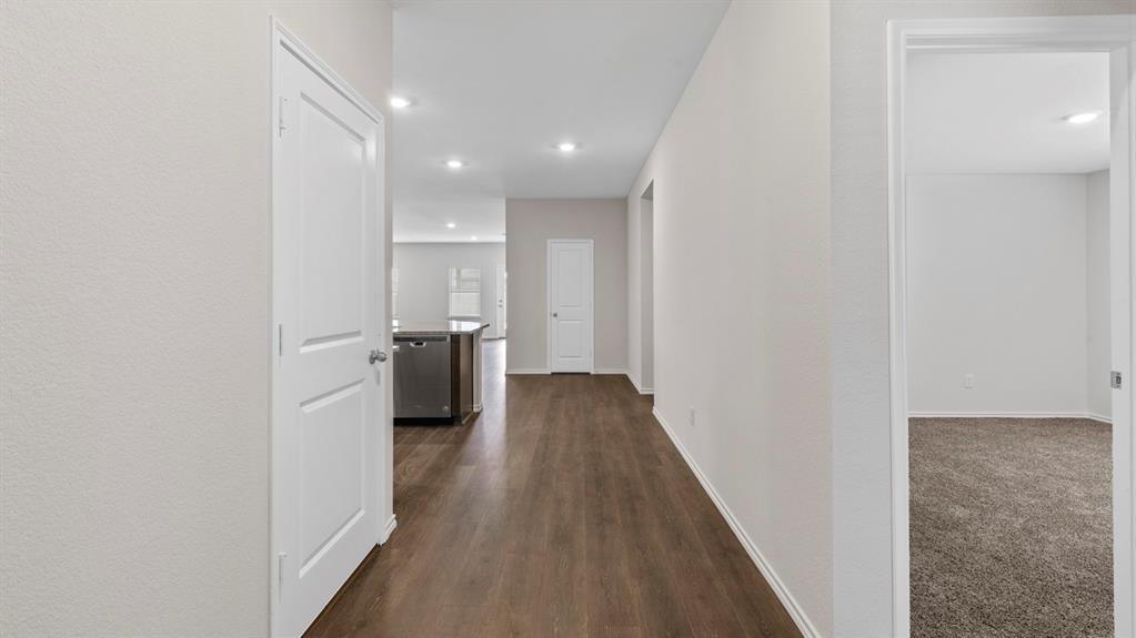 Hallway featuring wood-finish flooring, recessed lighting, and neutral wall tones