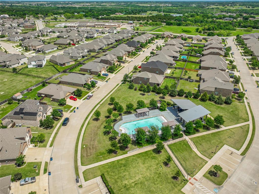 Community amenities featuring a swimming pool with surrounding deck, an open-air pavilion, and extensive green spaces