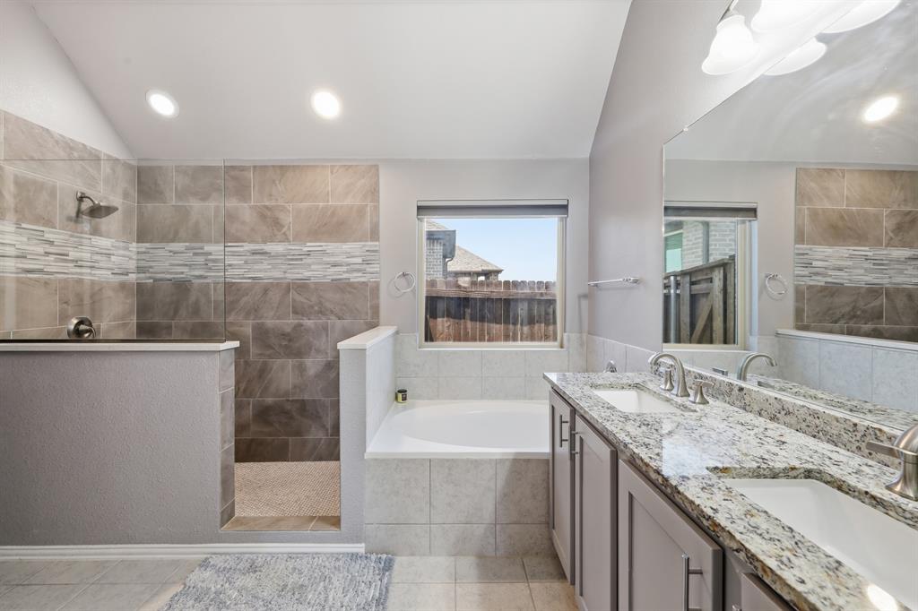 Primary bathroom is spacious and beautiful, dual sinks on large granite countertop. large walk in shower