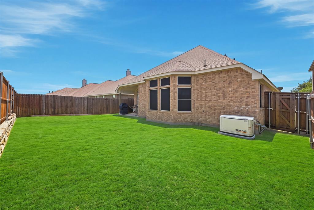 Another view of the backyard and back of the home - generator comes with the home