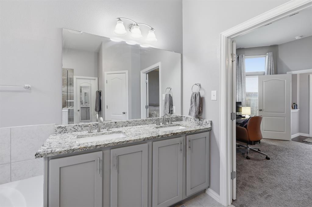 Double vanity featuring granite countertops with dual sinks