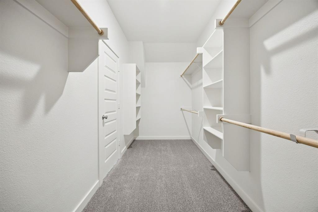 Primary Closet in the Heisman home plan by Trophy Signature Homes – REPRESENTATIVE PHOTO