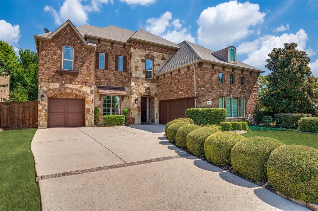 This former model home boasts professional custom landscaping, an expansive creek-side corner lot, and a sophisticated brick and stone facade, complemented by a spacious three-car garage with cedar-clad doors. This former model home boasts professional custom landscaping, an expansive creek-side corner lot, and a sophisticated brick and stone facade, complemented by a spacious three-car garage with cedar-clad doors.