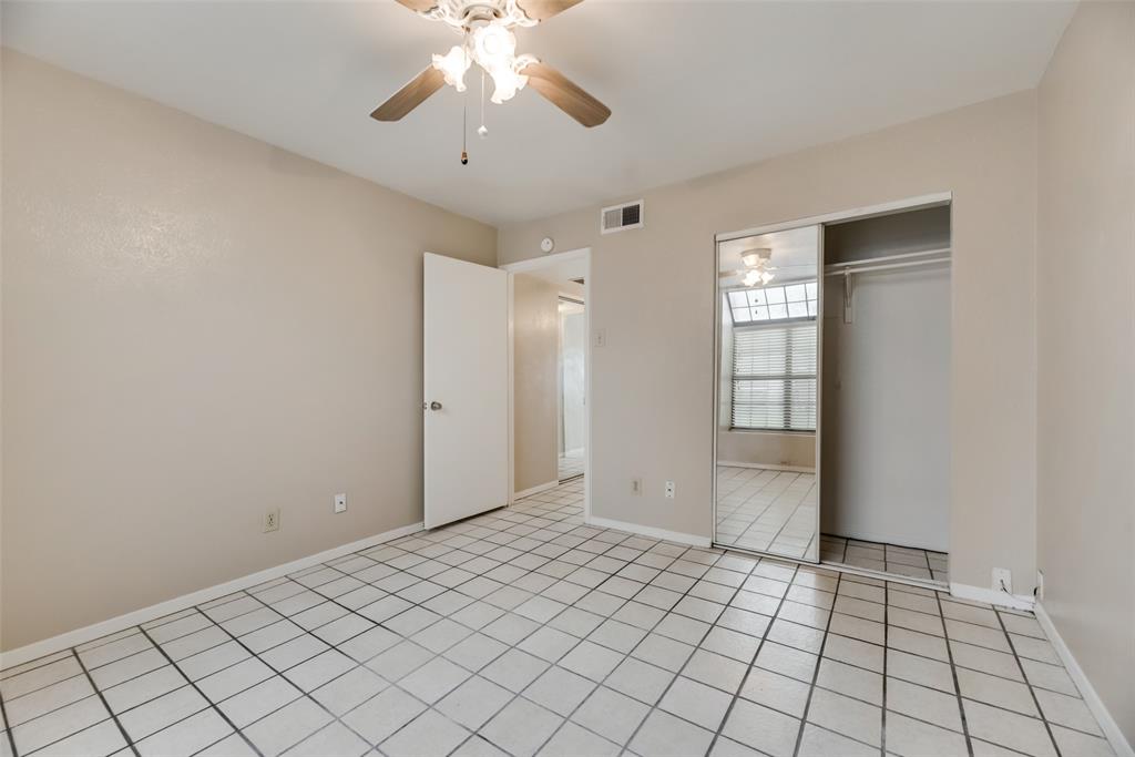 Unfurnished bedroom featuring a closet, ceiling fan, and light tile flooring