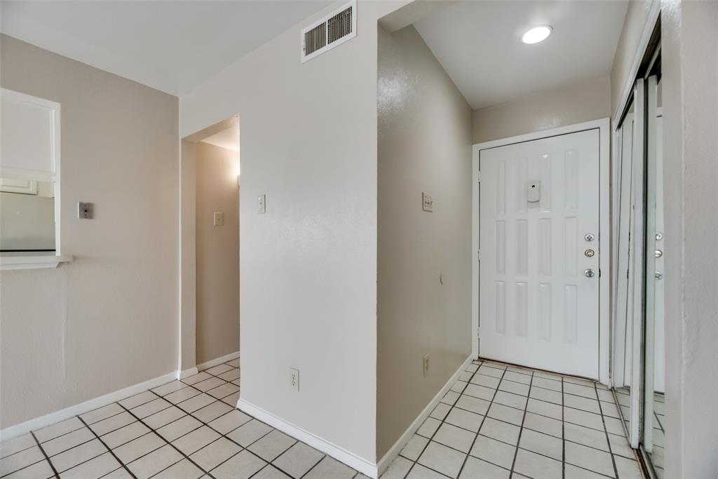 Foyer entrance featuring light tile flooring