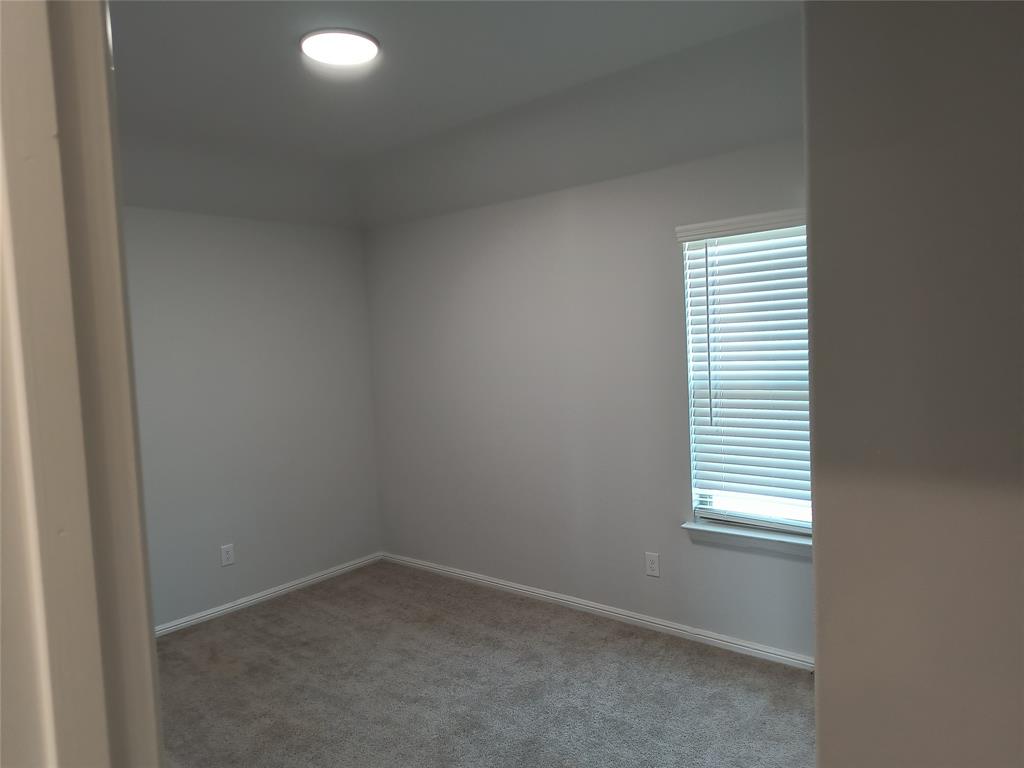 Recessed ceiling light, neutral wall paint, window with blinds, and carpeting