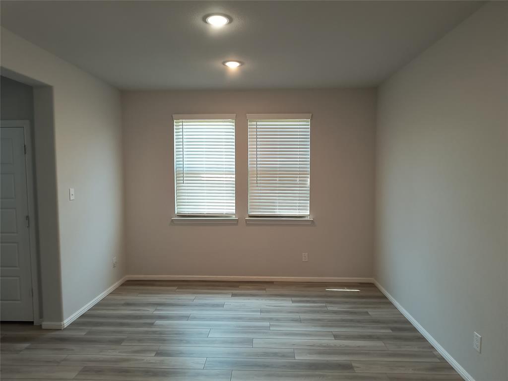 Recessed lighting, wood-finish flooring, and two windows with blinds Recessed lighting, wood-finish flooring, and two windows with blinds
