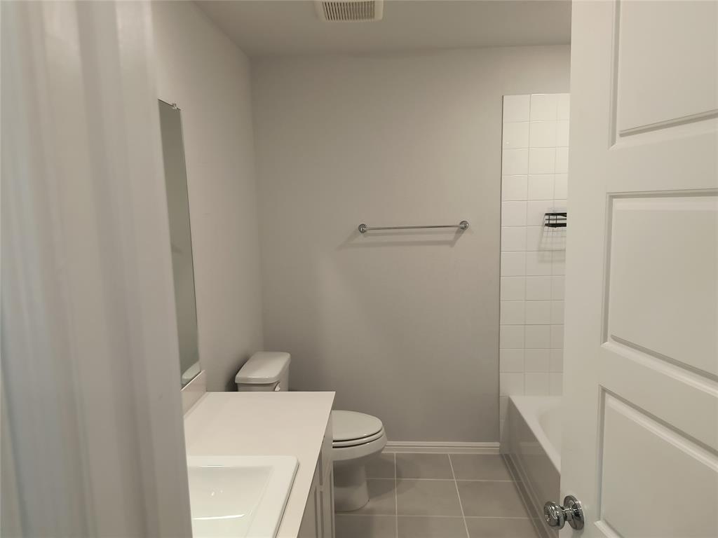 Vanity with a white countertop and integrated sink, chrome faucet, and rectangular mirror