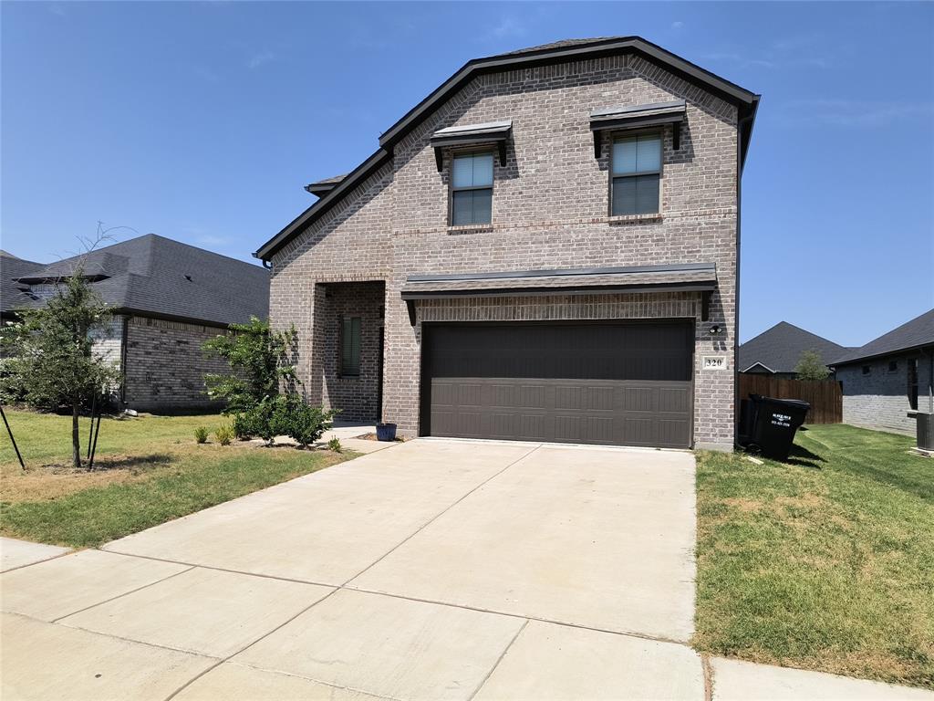 Brick exterior with attached garage, concrete driveway, and covered entry Brick exterior with attached garage, concrete driveway, and covered entry