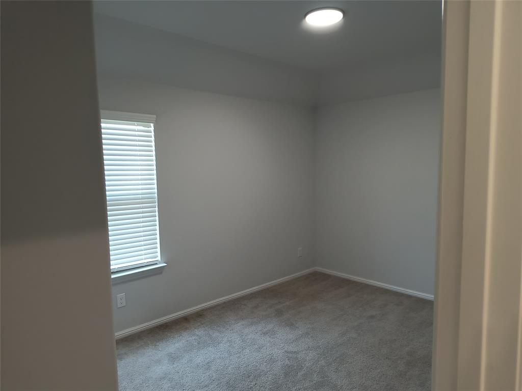 Carpeted flooring, recessed ceiling lighting, and window with horizontal blinds