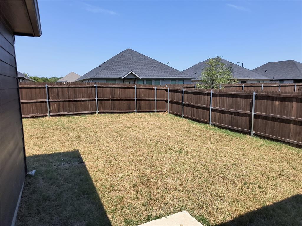 Fenced yard with wood fencing and metal posts Fenced yard with wood fencing and metal posts
