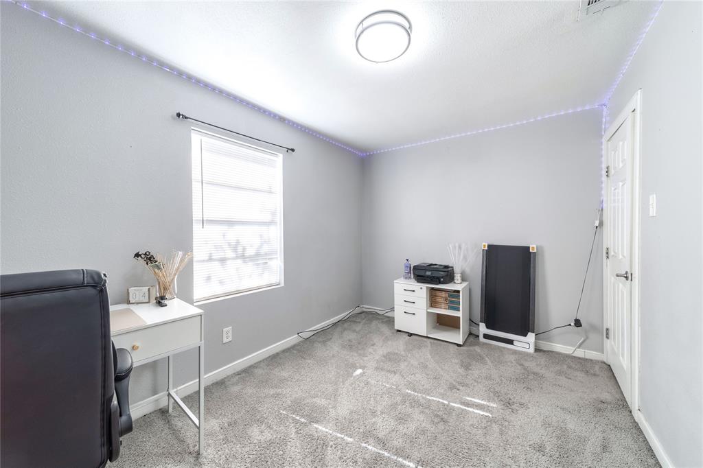 Carpeted office space featuring baseboards