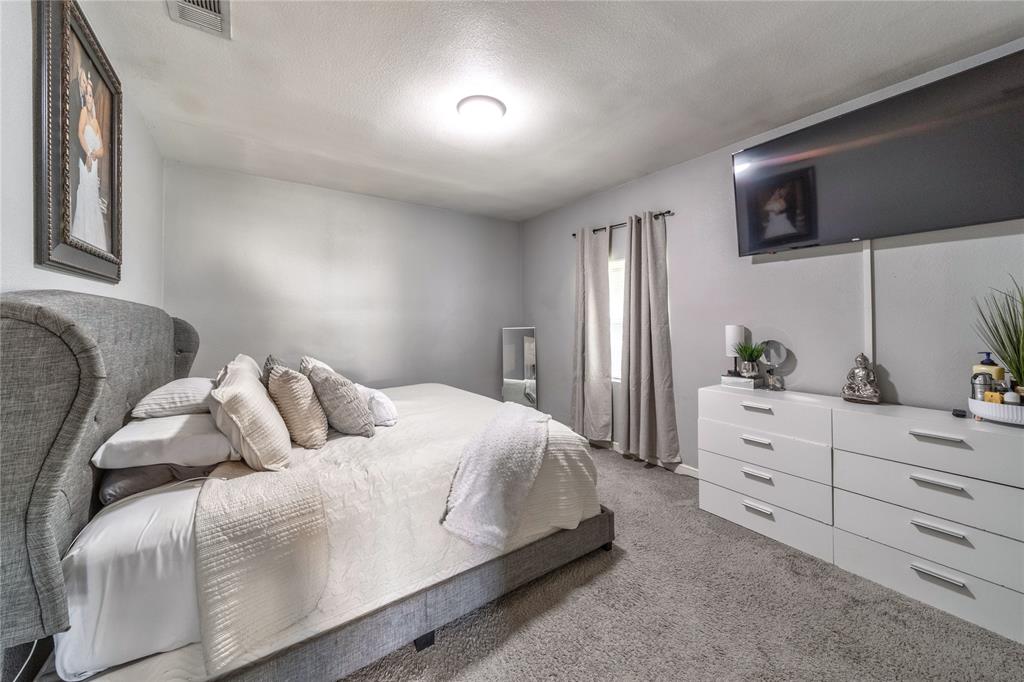 Carpeted bedroom with a textured ceiling