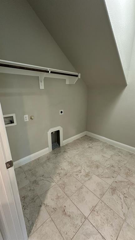 Spacious reach-in closet featuring six built-in shelves with white painted trim and soft natural lighting
