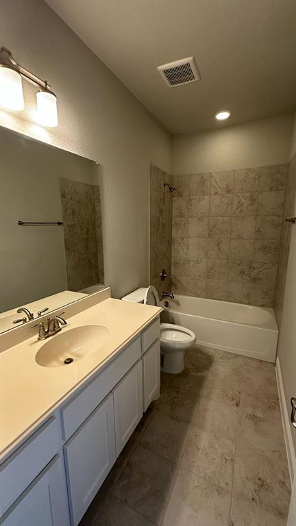 Two garage doors with automatic openers, concrete flooring, and overhead lighting
