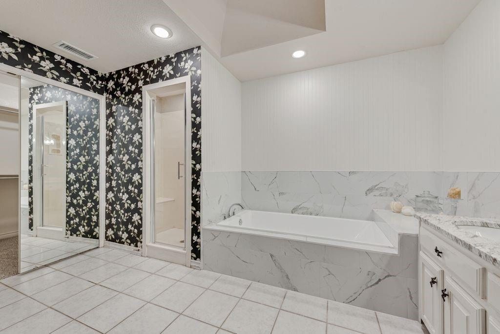 Soaking tub with marble-look tile surround