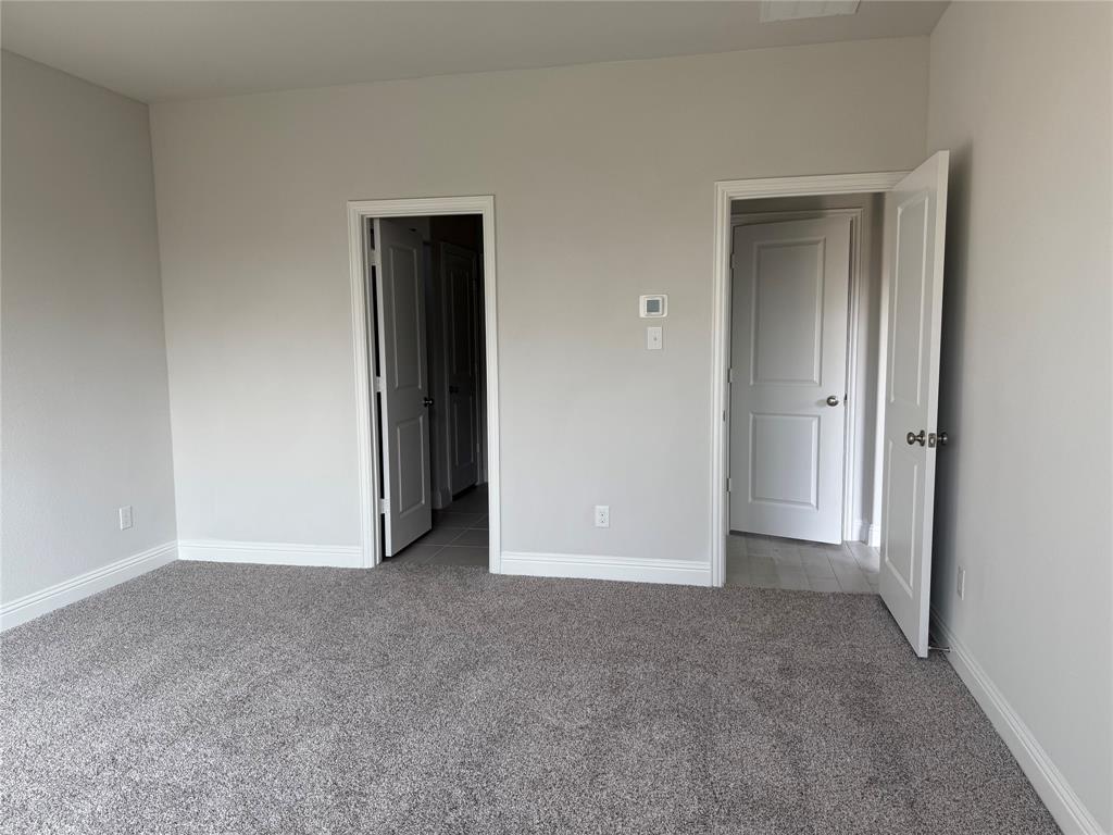 Plush carpeting, light-toned walls, and white trim throughout