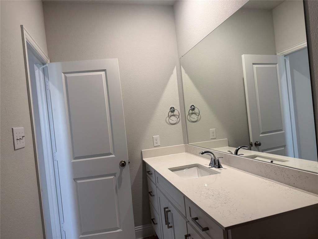 Integrated vanity with an undermount sink, a chrome faucet, and ample countertop space