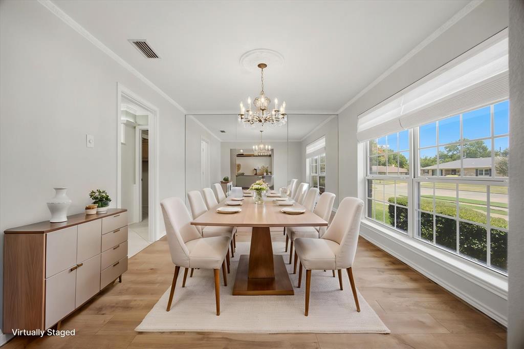 Virtually staged formal dining area conveniently located next to the kitchen- perfect for effortless entertaining. This area also features the Hunter Douglas Vignette Stacking Lite Rise Top Down-Bottom-Up window shades.  Convenient and very classic.