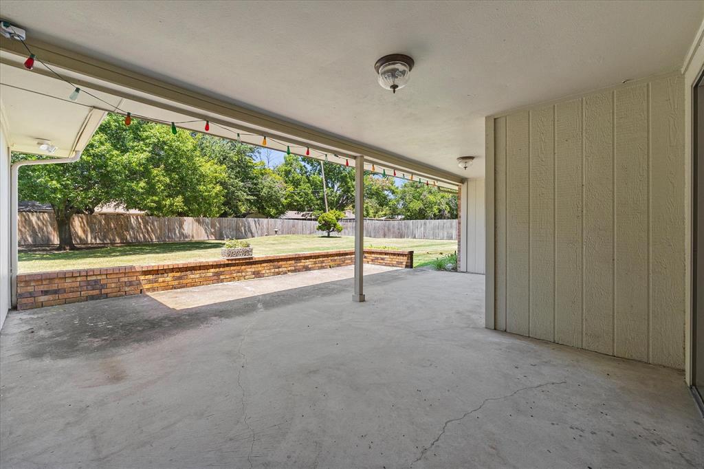 Covered patio overlooking the spacious backyard.