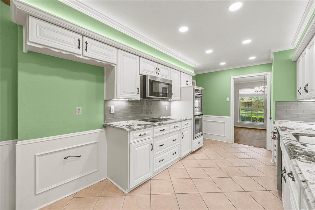 Updated appliances including double oven, dishwasher, and microwave. Electrical stove top is plumbed for gas.