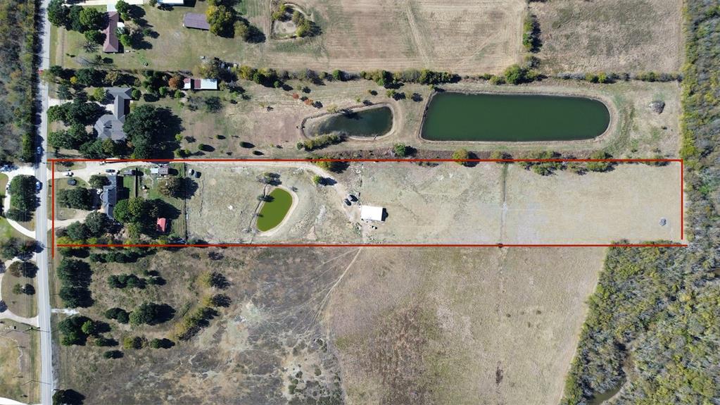View of rural area with property parcel outlined and a large body of water