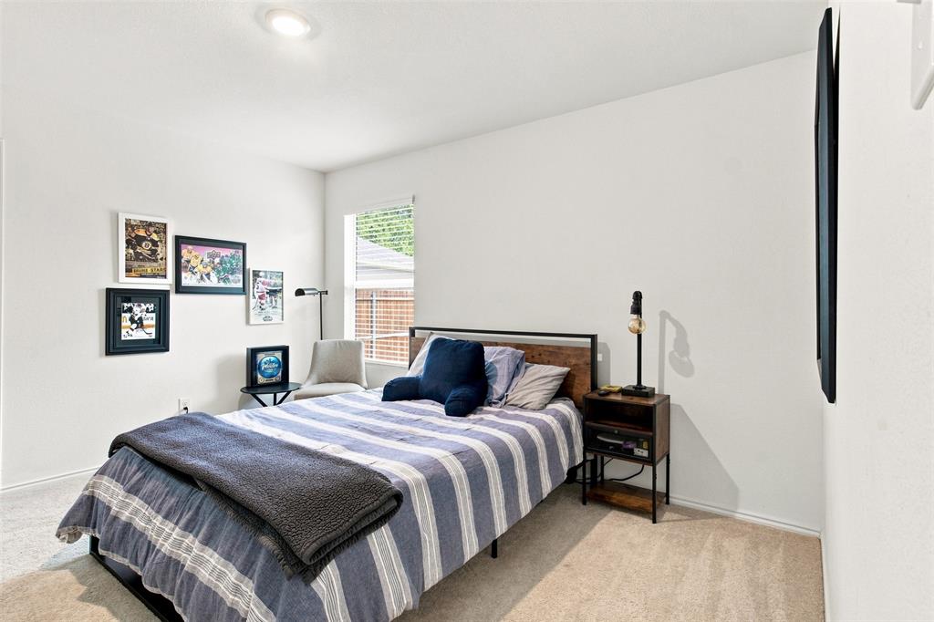 Recessed ceiling lighting, light-colored carpeting, window with blinds, white wall finishes, and a wall-mounted flat screen