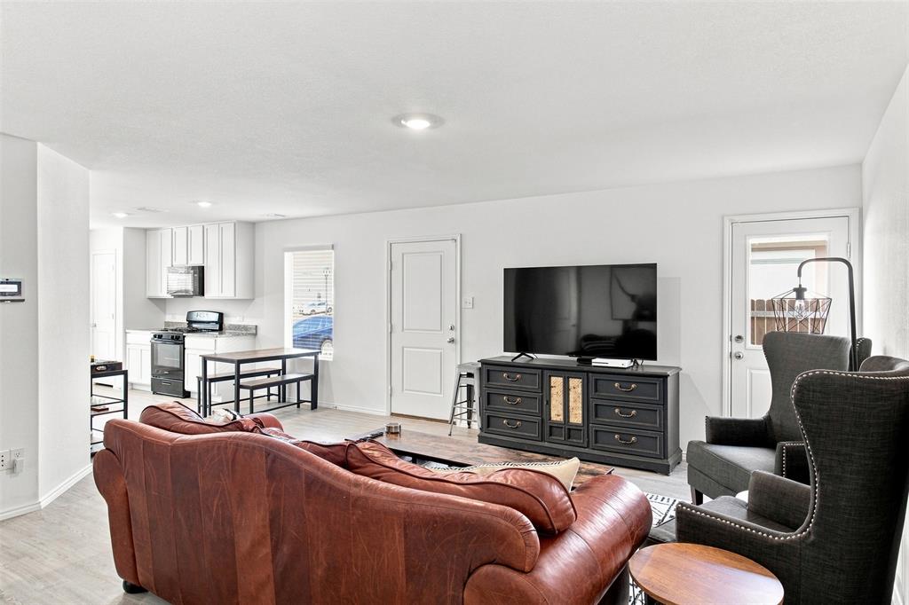 Open-concept living area with light wood-finish flooring
