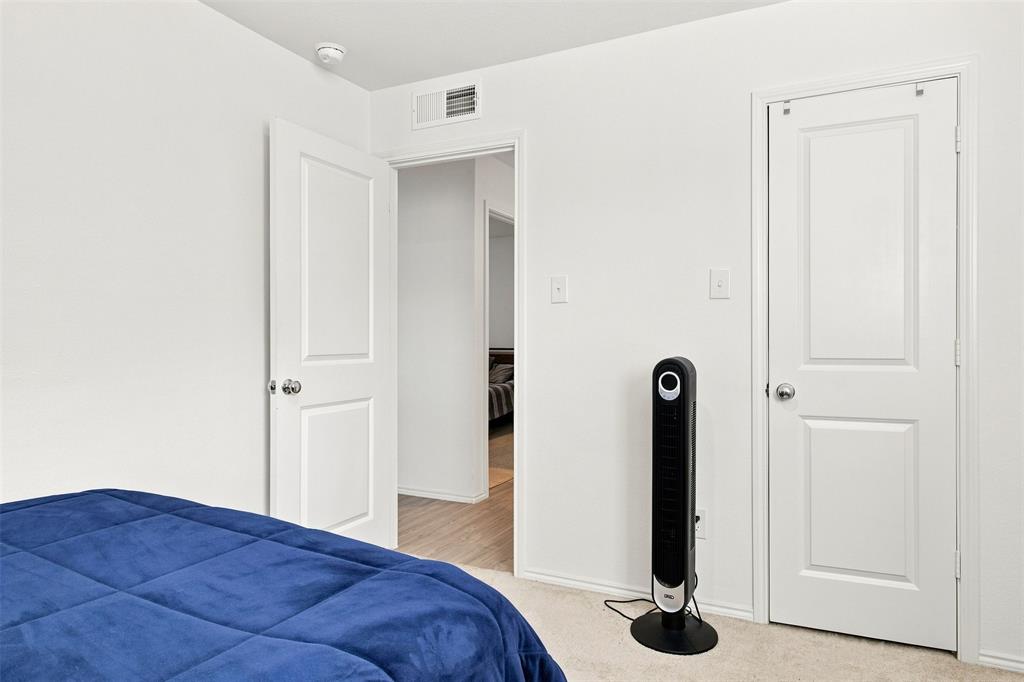 White interior doors, wall-to-wall carpeting, and a smoke detector
