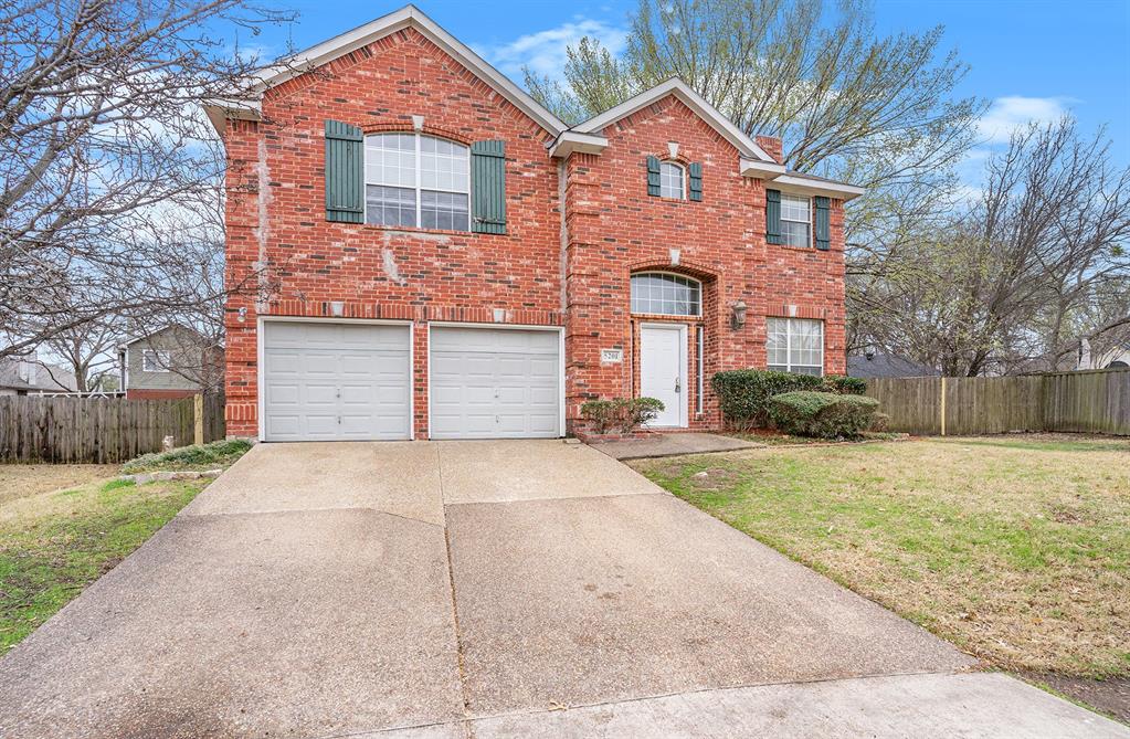 View of property with a front yard and a garage